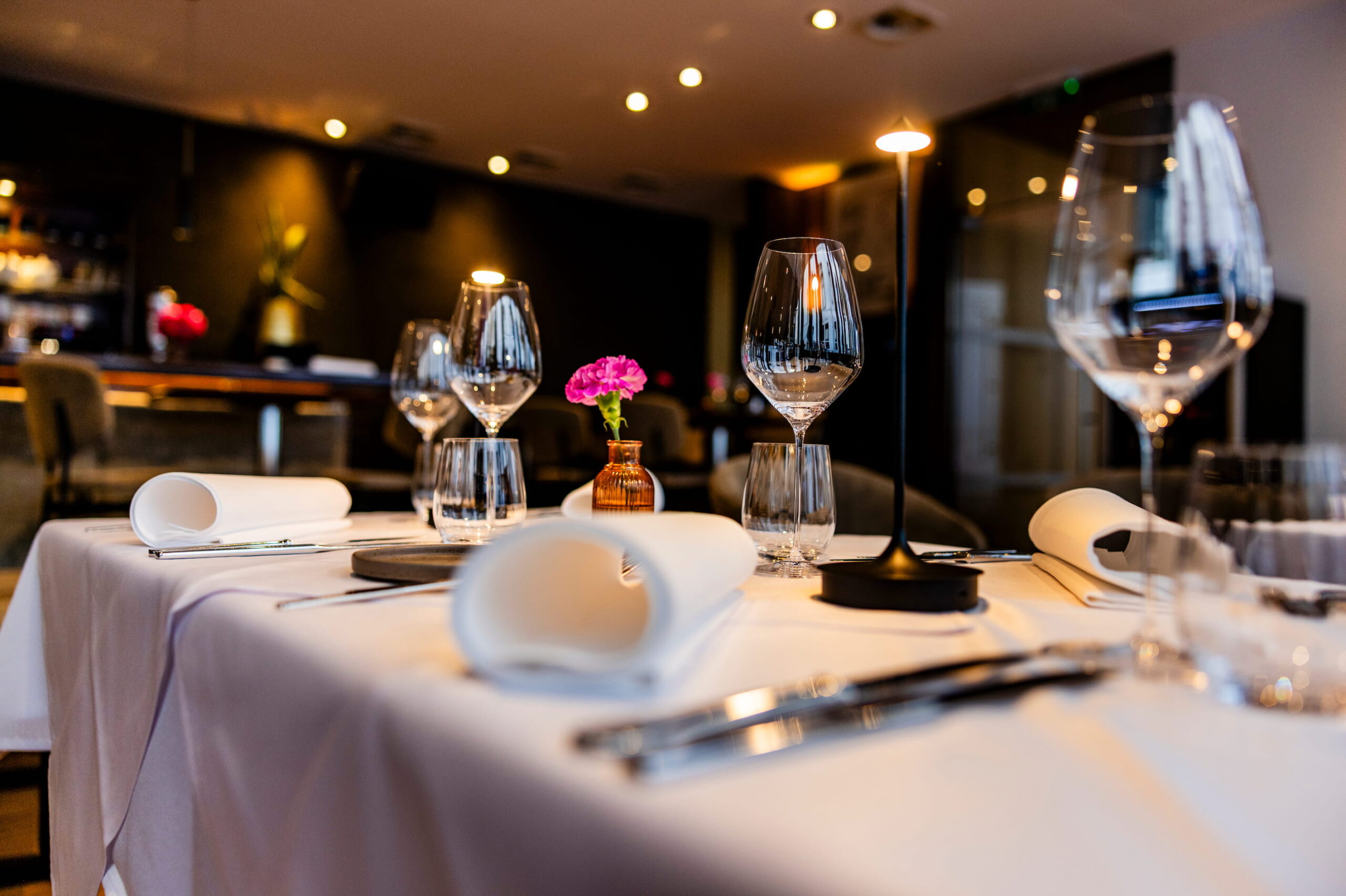 a set table, flowers, and ceiling lights